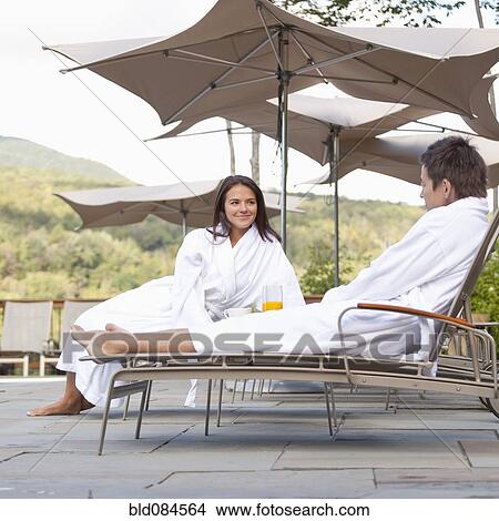Picture - Couple enjoying breakfast near swimming pool. Fotosearch
