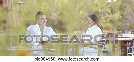 Stock Image - Couple enjoying breakfast on outdoor patio. Fotosearch