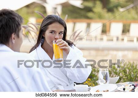 Couple enjoying breakfast on outdoor patio View Large Photo Image Stock Photograph - Couple enjoying breakfast on outdoor patio. Fotosearch