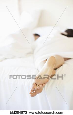 Couple laying in bed together View Large Photo Image Stock Image - Couple laying in bed together. Fotosearch