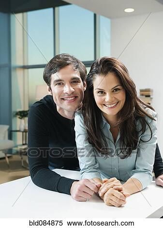 Stock Photography - Couple leaning together on counter. Fotosearch