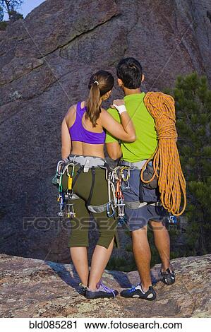 Couple preparing for rock climbing View Large Photo Image Stock Image - Couple preparing for rock climbing. Fotosearch