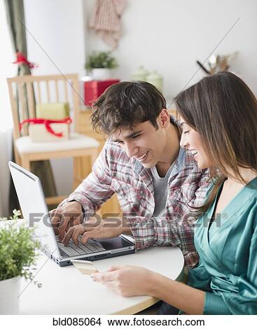 Couple shopping online with credit card View Large Photo Image Picture - Couple shopping online with credit card. Fotosearch