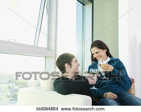 Picture - Couple sitting together and drinking wine. Fotosearch