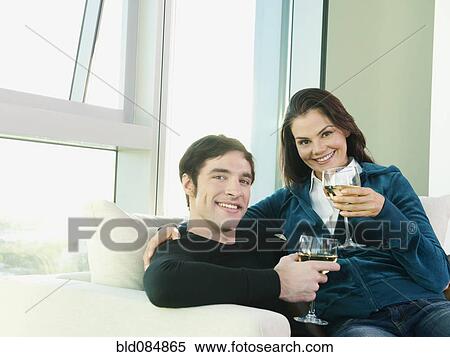 Couple sitting together and drinking wine View Large Photo Image Stock Photography - Couple sitting together and drinking wine. Fotosearch