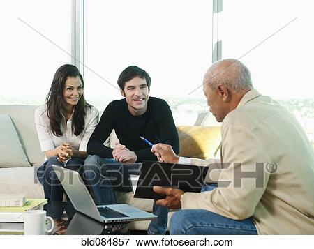 Stock Photo - Couple talking to financial advisor. Fotosearch