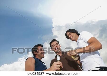 Stock Photo - Friends hanging out and drinking beer. Fotosearch