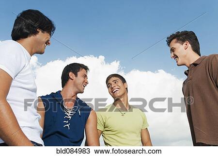 Stock Image - Friends laughing together outdoors. Fotosearch