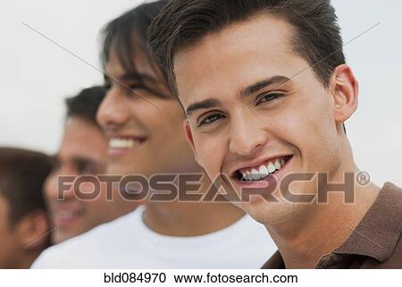 Friends standing a row View Large Photo Image Stock Image - Friends standing a row. Fotosearch