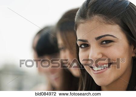 Stock Image - Friends standing in a row. Fotosearch