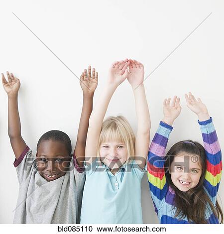 Friends standing with arms raised View Large Photo Image Stock Image - Friends standing with arms raised. Fotosearch