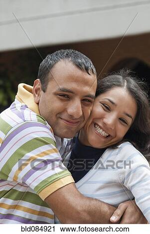Stock Image - Hispanic couple hugging. Fotosearch