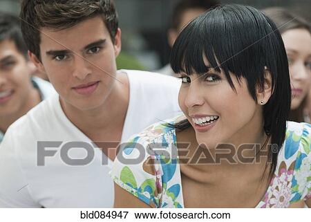 Stock Photo - Hispanic friends hanging out together. Fotosearch