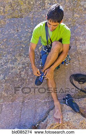Hispanic man preparing for rock climbing View Large Photo Image Picture - Hispanic man preparing for rock climbing. Fotosearch