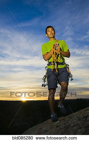 Hispanic man preparing for rock climbing View Large Photo Image Stock Image - Hispanic man preparing for rock climbing. Fotosearch