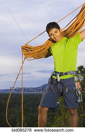 Hispanic man preparing for rock climbing View Large Photo Image Stock Photo - Hispanic man preparing for rock climbing. Fotosearch