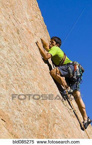Hispanic man rock climbing View Large Photo Image Stock Photography - Hispanic man rock climbing. Fotosearch
