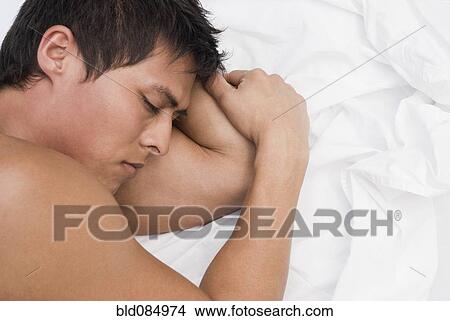 Hispanic man sleeping in bed View Large Photo Image Picture - Hispanic man sleeping in bed. Fotosearch