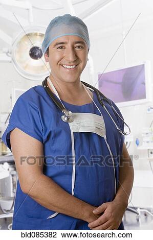 Stock Image - Hispanic surgeon in operating room. Fotosearch