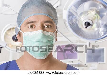 Stock Image - Hispanic surgeon in operating room. Fotosearch