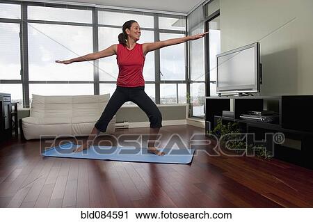 Hispanic woman exercising on yoga mat View Large Photo Image Stock Image - Hispanic woman exercising on yoga mat. Fotosearch