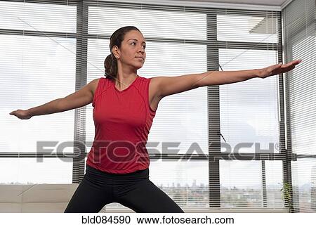 Stock Image - Hispanic woman exercising. Fotosearch