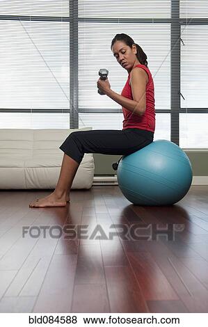 Hispanic woman exercising with hand weights View Large Photo Image Stock Photo - Hispanic woman exercising with hand weights. Fotosearch
