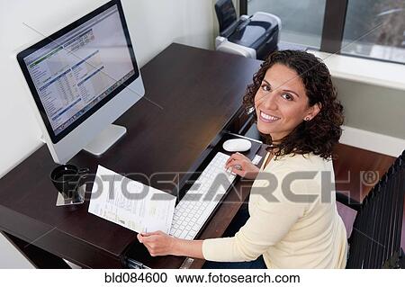 Hispanic woman paying bills on computer View Large Photo Image Stock Image - Hispanic woman paying bills on computer. Fotosearch