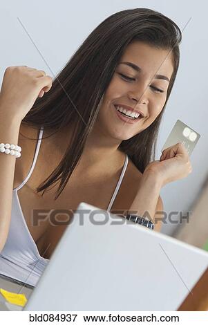 Hispanic woman shopping online with credit card View Large Photo Image Stock Photo - Hispanic woman shopping online with credit card. Fotosearch