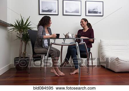 Hispanic women talking and drinking coffee View Large Photo Image Stock Photography - Hispanic women talking and drinking coffee. Fotosearch