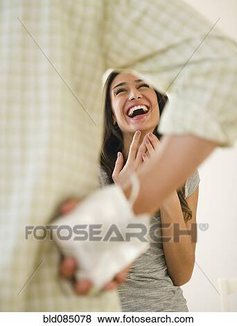Stock Photo - Husband giving gift to laughing wife. Fotosearch