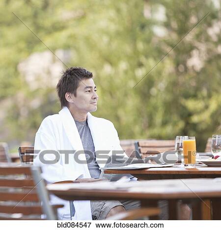 Man enjoying breakfast on outdoor patio View Large Photo Image Stock Photo - Man enjoying breakfast on outdoor patio. Fotosearch