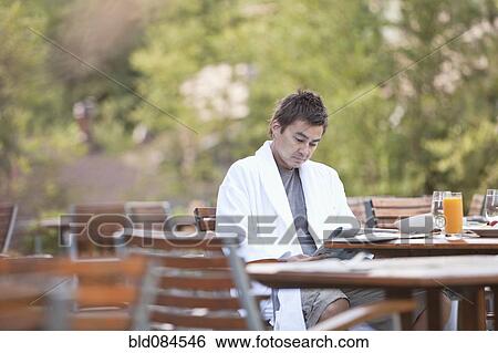 Man enjoying breakfast on outdoor patio View Large Photo Image Stock Photograph - Man enjoying breakfast on outdoor patio. Fotosearch