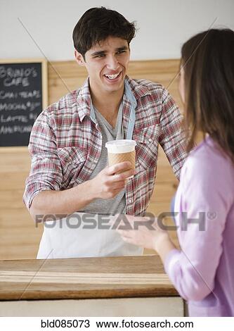 Man serving woman coffee to go View Large Photo Image Stock Image - Man serving woman coffee to go. Fotosearch