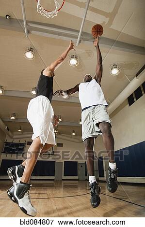 Men playing basketball on basketball court View Large Photo Image Stock Photo - Men playing basketball on basketball court. Fotosearch