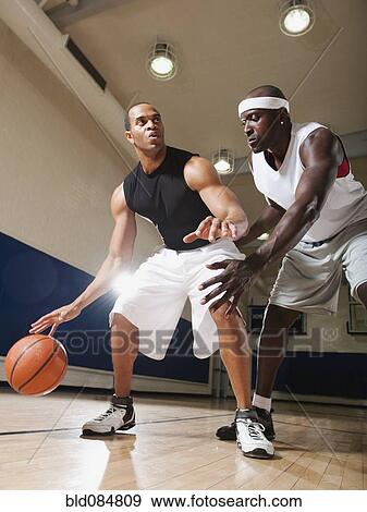 Men playing basketball on basketball court View Large Photo Image Stock Photo - Men playing basketball on basketball court. Fotosearch