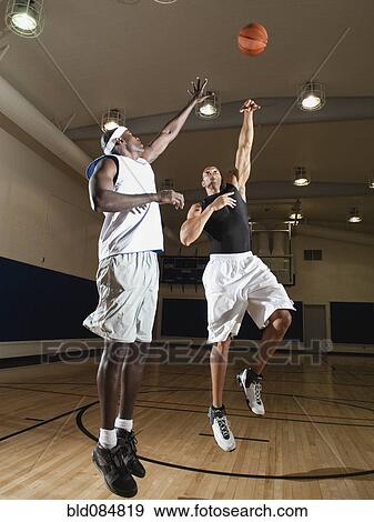 Men playing basketball on basketball court View Large Photo Image Stock Photo - Men playing basketball on basketball court. Fotosearch