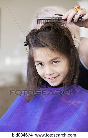 Mixed Race Girl Getting Her Hair Cut Picture Bld084674 Fotosearch