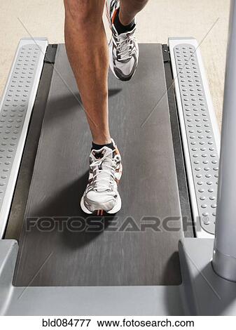 Mixed race man's legs running on treadmill View Large Photo Image Stock Photo - Mixed race man's legs running on treadmill. Fotosearch
