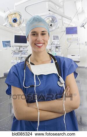 Picture - Mixed race surgeon in operating room. Fotosearch