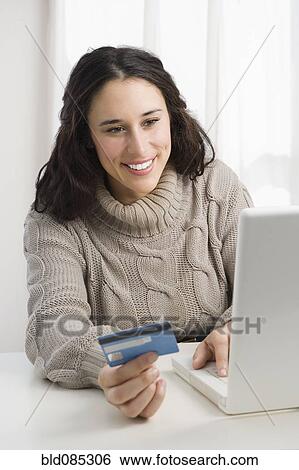 Mixed race woman shopping online with credit card View Large Photo Image Stock Photograph - Mixed race woman shopping online with credit card. Fotosearch