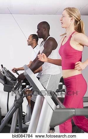 Picture - People exercising in health club. Fotosearch