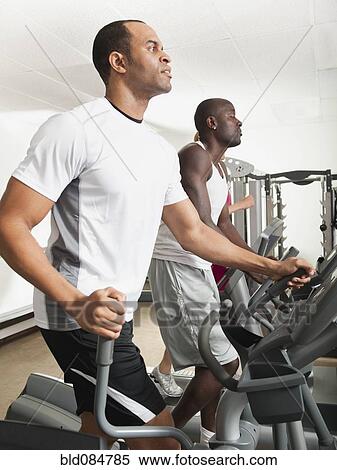 Stock Photography - People exercising in health club. Fotosearch
