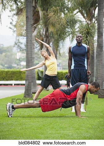 People exercising in park together View Large Photo Image Stock Image - People exercising in park together. Fotosearch