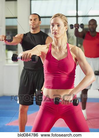 People exercising with hand weights in health club View Large Photo Image Stock Photograph - People exercising with hand weights in health club. Fotosearch