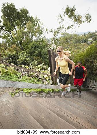 Stock Photo - People running up stairs for exercise. Fotosearch