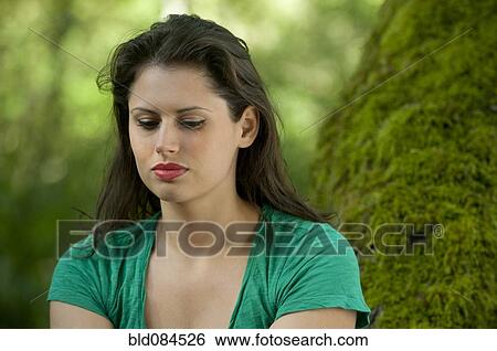 Serious Caucasian woman sitting in forest View Large Photo Image Stock Photograph - Serious Caucasian woman sitting in forest. Fotosearch
