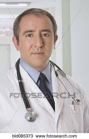 Stock Image - Serious Hispanic doctor. Fotosearch