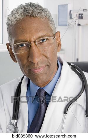 Stock Image - Serious mixed race doctor. Fotosearch
