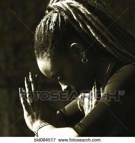 Stock Photo - Serious woman praying. Fotosearch